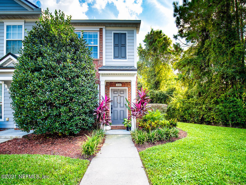 3586 Pebble Path Lane Jacksonville, FL 32224 - Photo 2 of 21 a front view of a house with a yard and fountain