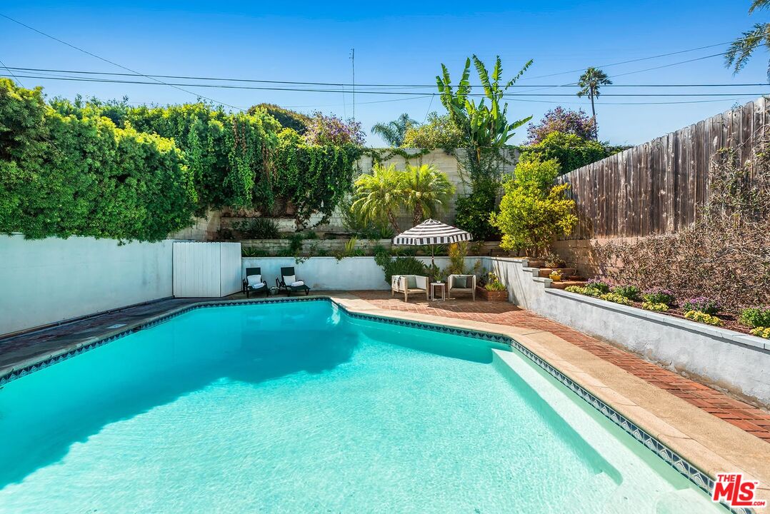 7517 Earldom Avenue Playa del Rey, CA 90293 - Photo 20 of 27 a view of yard with swimming pool and trees in the background