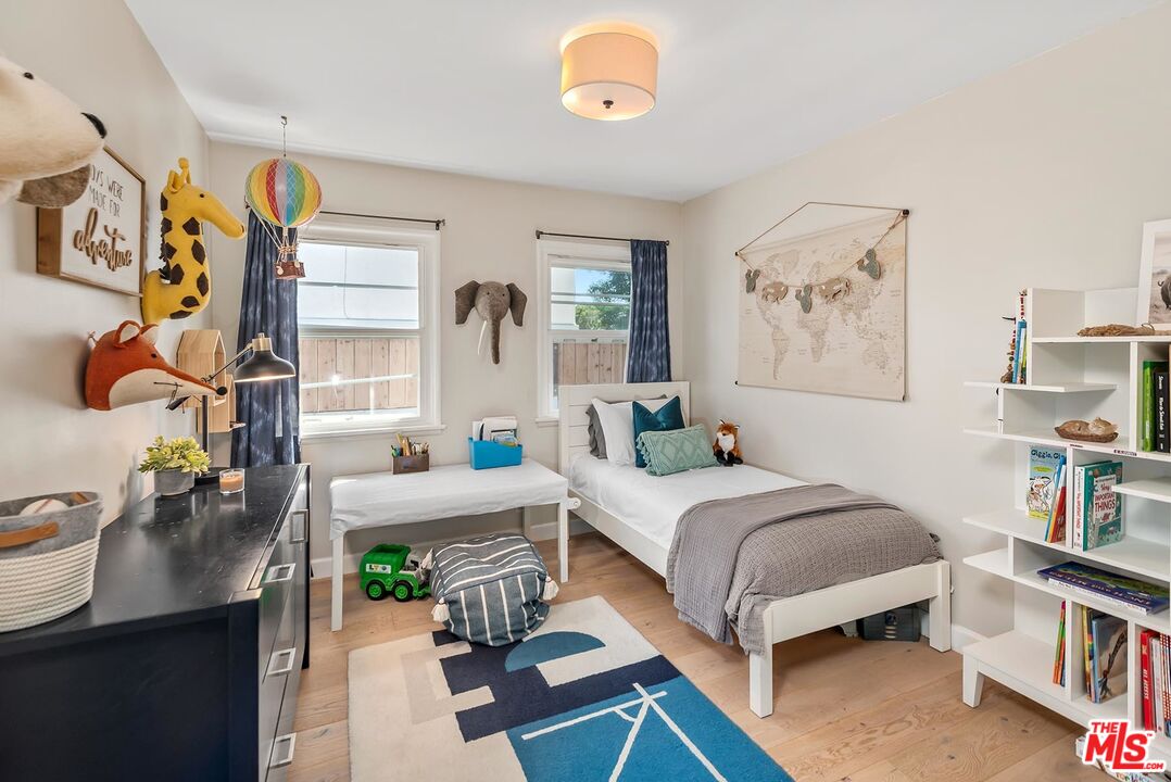 7517 Earldom Avenue Playa del Rey, CA 90293 - Photo 22 of 27 a bed room with a bed and a book shelf