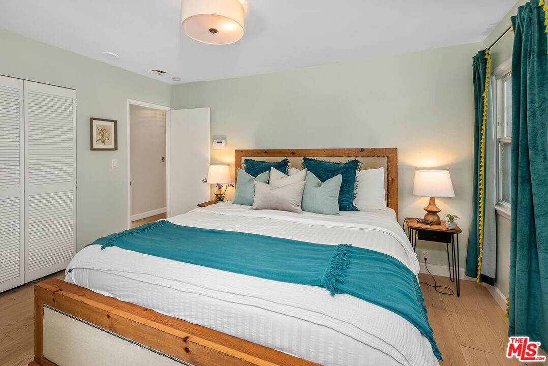 7517 Earldom Avenue Playa del Rey, CA 90293 - Photo 25 of 27 a bedroom with a bed and a lamp next to a window