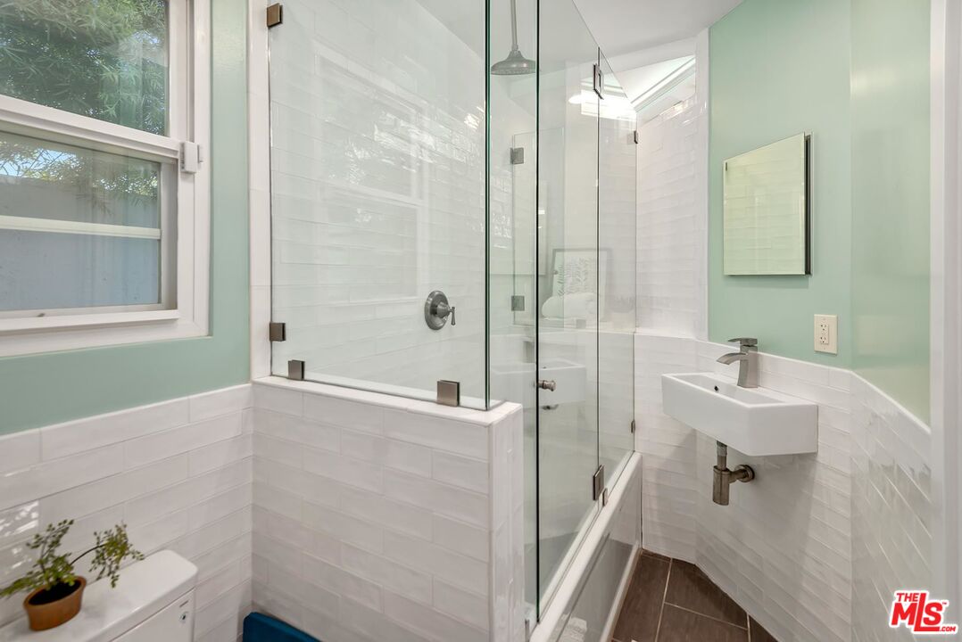 7517 Earldom Avenue Playa del Rey, CA 90293 - Photo 26 of 27 a bathroom with a bathtub a sink and a shower