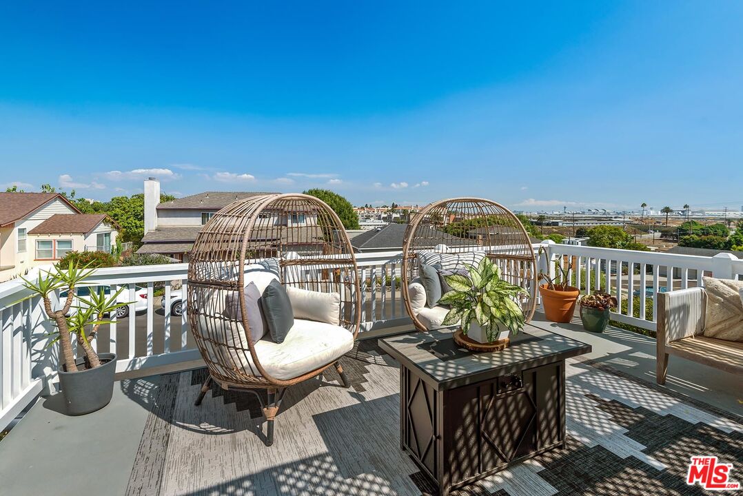 7517 Earldom Avenue Playa del Rey, CA 90293 - Photo 6 of 27 a view of a balcony with chairs and potted plants