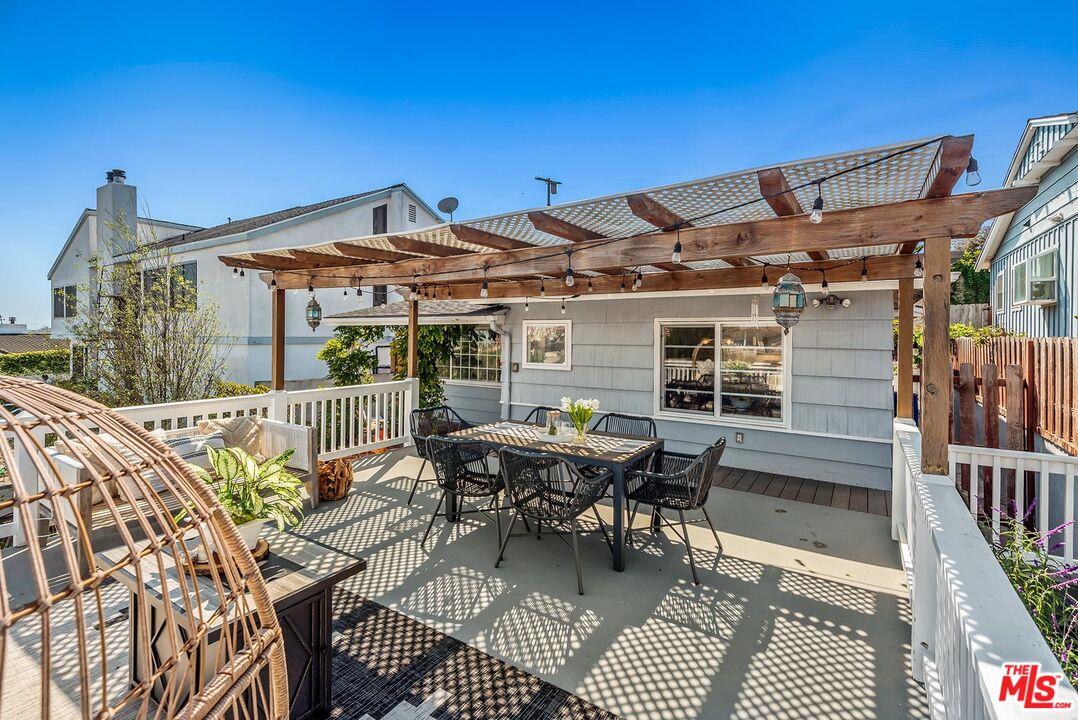 7517 Earldom Avenue Playa del Rey, CA 90293 - Photo 8 of 27 a patio with glass top table and chairs