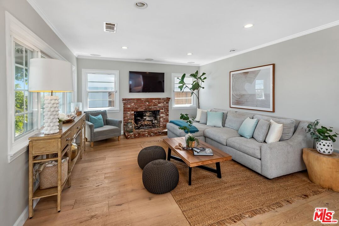 7517 Earldom Avenue Playa del Rey, CA 90293 - Photo 10 of 27 a living room with furniture a flat screen tv and a fireplace
