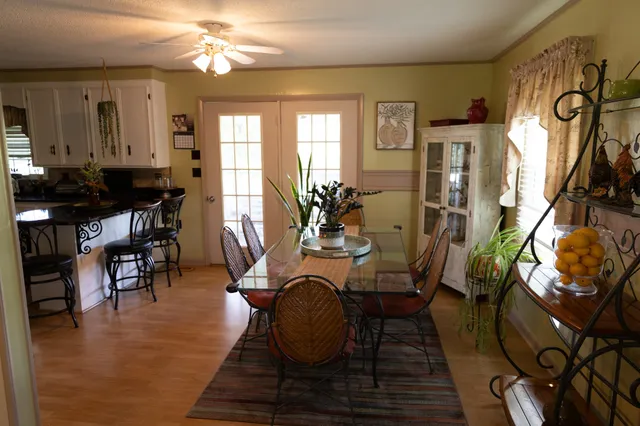 a view of a dining room with furniture and wooden floor