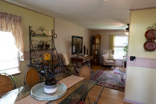 a living room with furniture chess and a fireplace