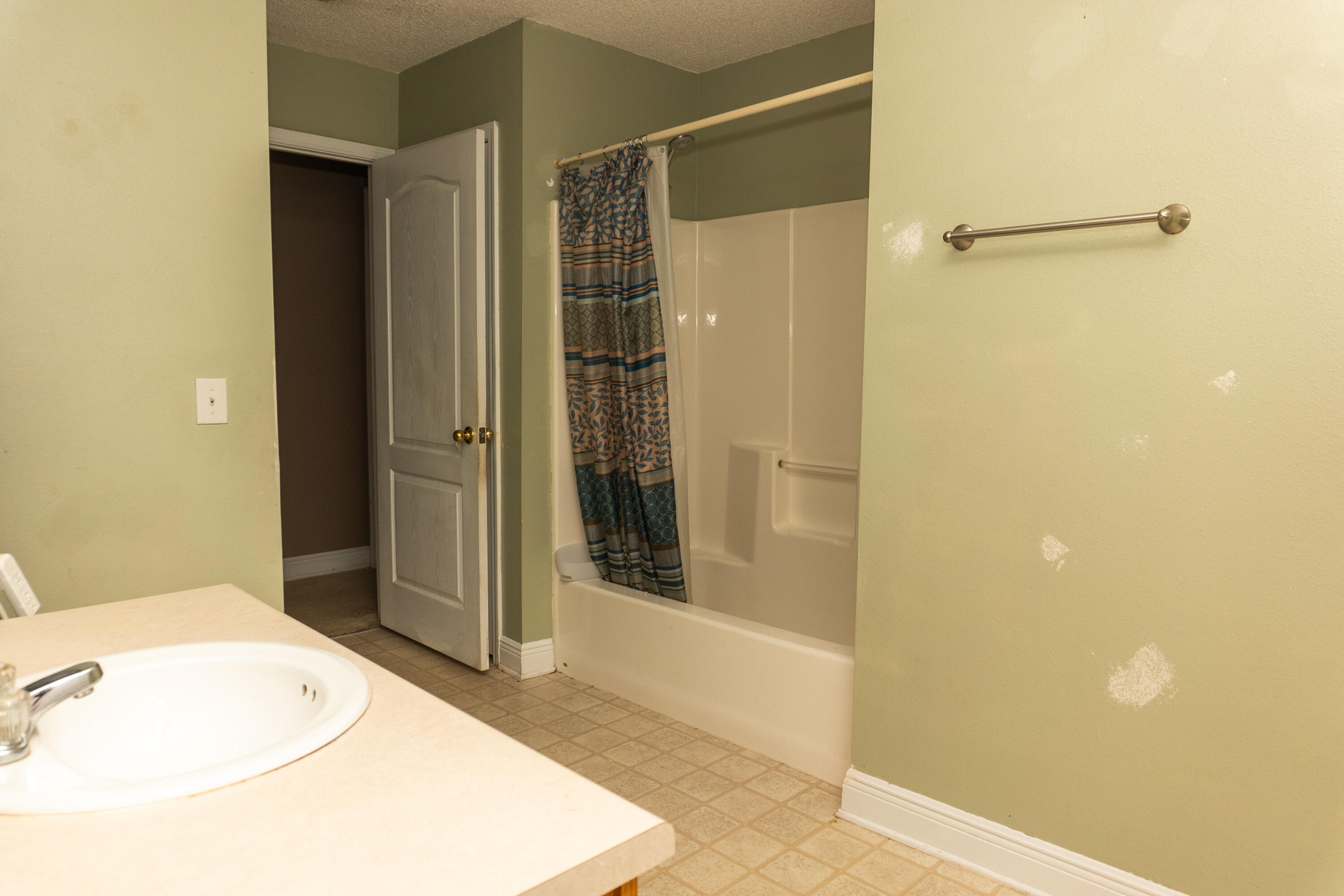 516 Vulpes Sanctuary Loop Crestview, FL 32536 - Photo 14 of 33 a bathroom with a shower and a sink