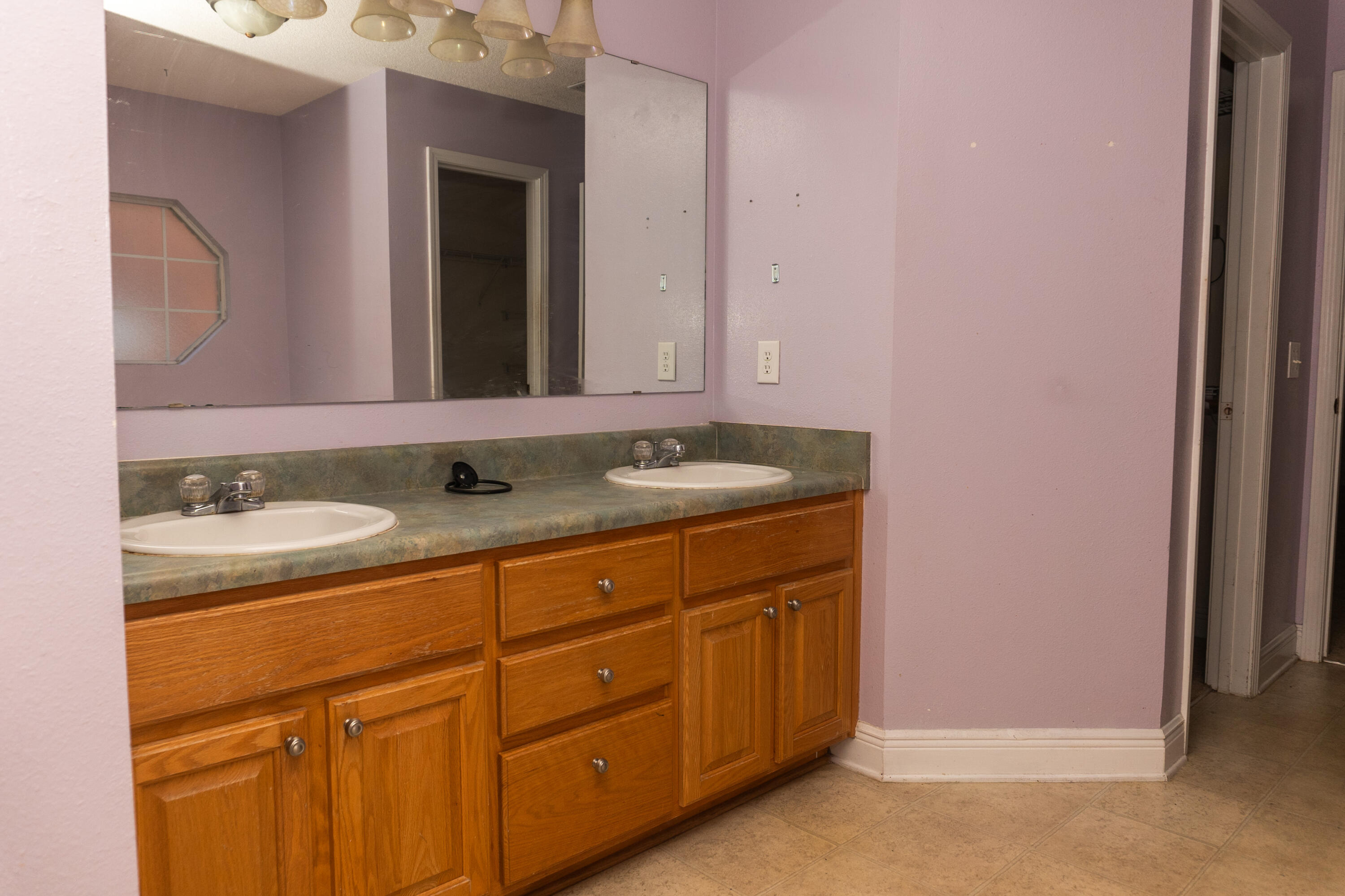 516 Vulpes Sanctuary Loop Crestview, FL 32536 - Photo 23 of 33 a bathroom with a granite countertop sink and a mirror