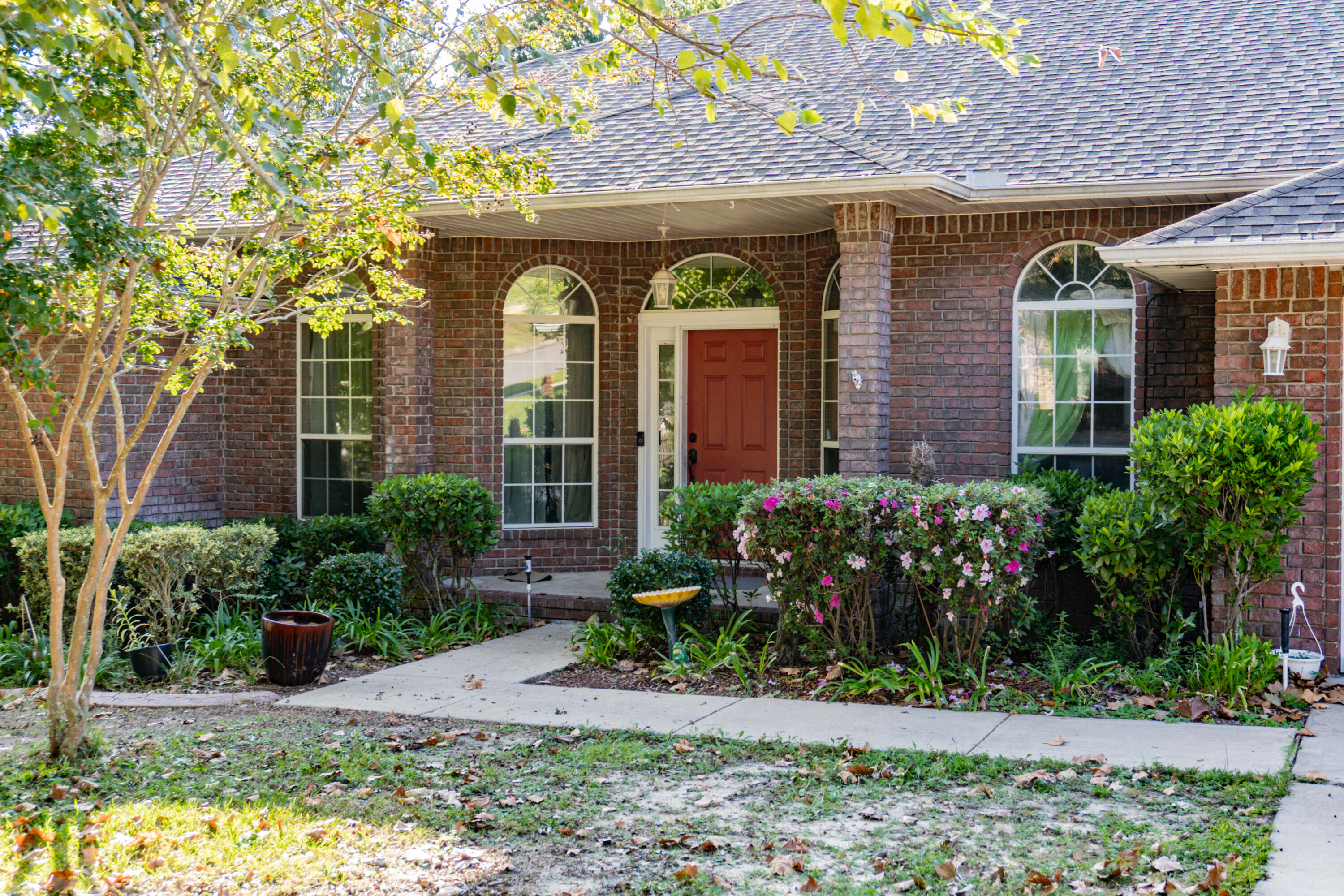 516 Vulpes Sanctuary Loop Crestview, FL 32536 - Photo 4 of 33 a front view of a house with garden