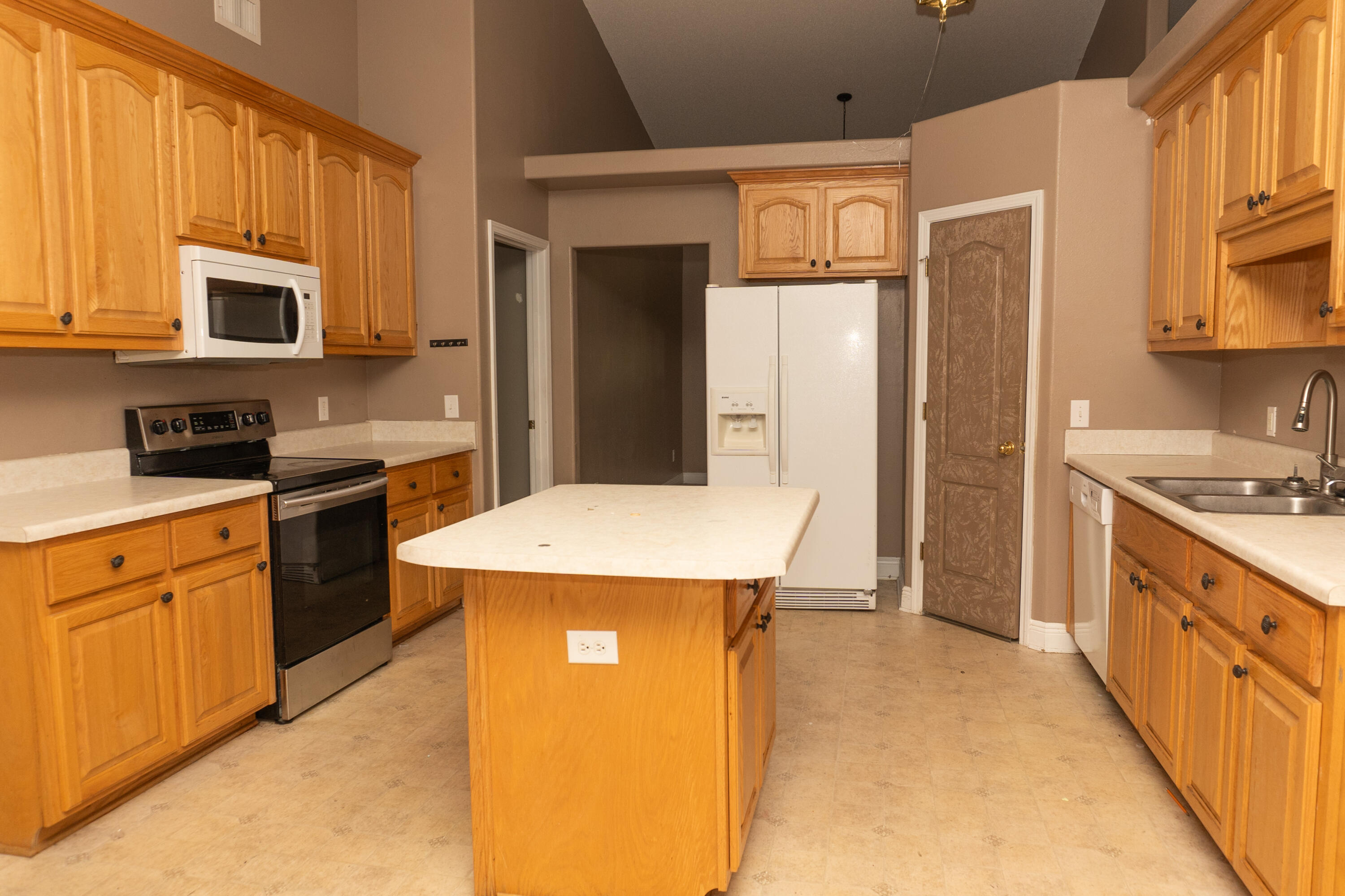 516 Vulpes Sanctuary Loop Crestview, FL 32536 - Photo 5 of 33 a kitchen with stainless steel appliances granite countertop a sink stove and refrigerator
