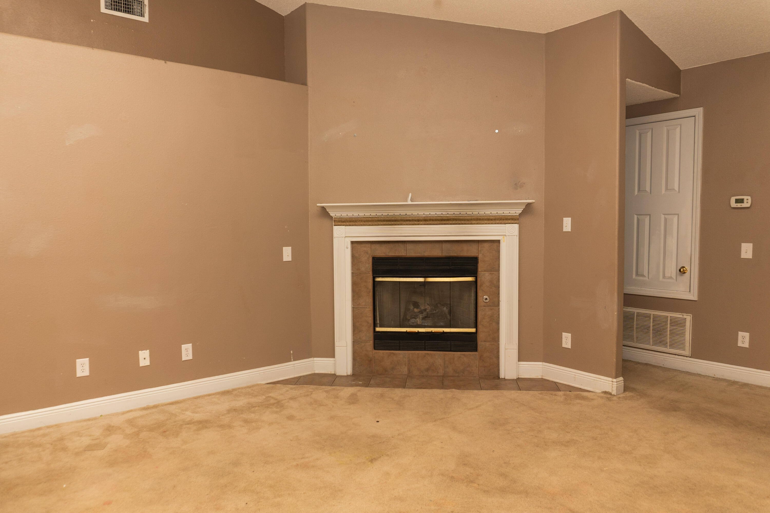 516 Vulpes Sanctuary Loop Crestview, FL 32536 - Photo 7 of 33 a view of an empty room with a fireplace