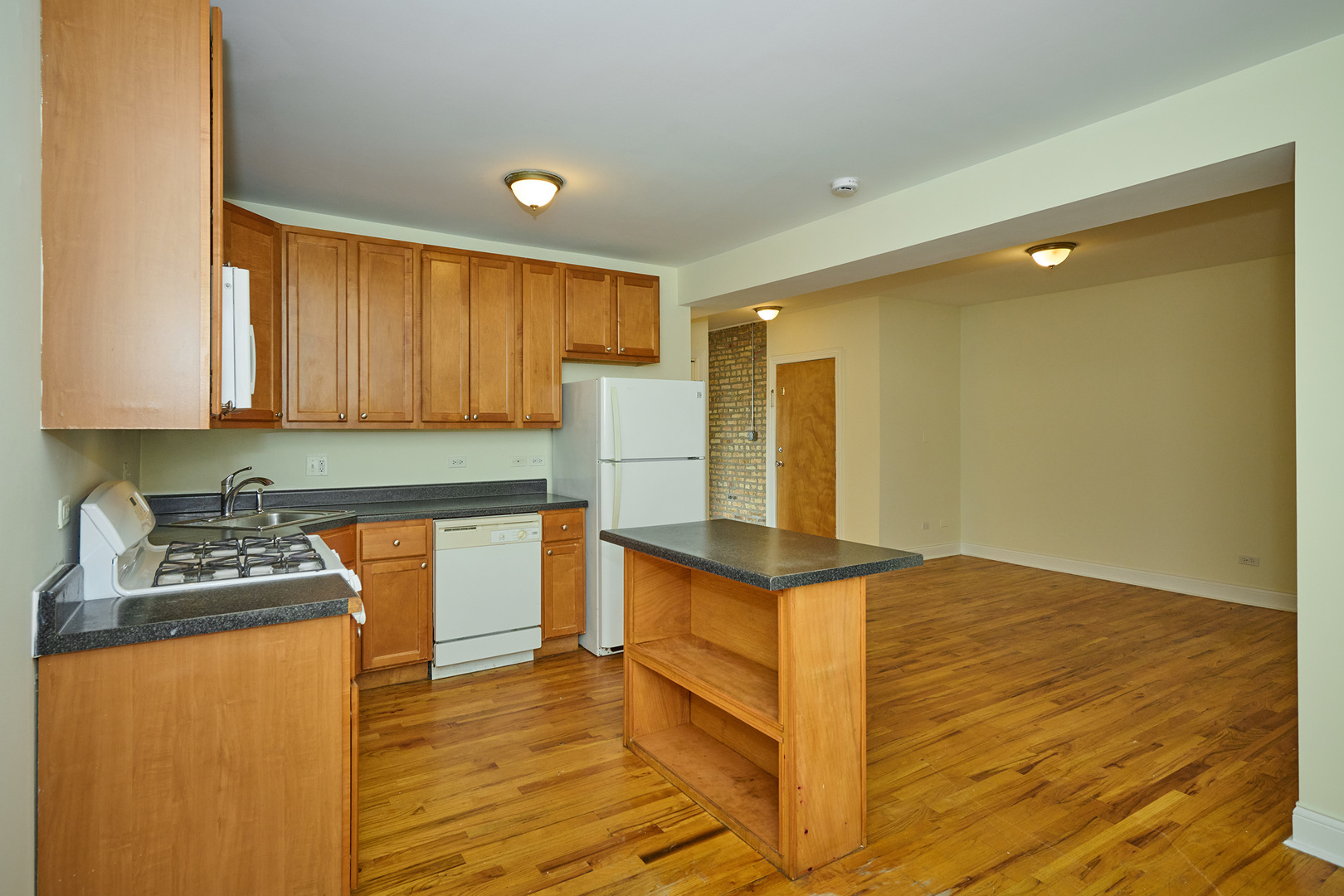 5014 North Harding Avenue, Unit 3S Chicago, IL 60625 - Photo 2 of 13 a kitchen with stainless steel appliances granite countertop a stove a sink and a refrigerator