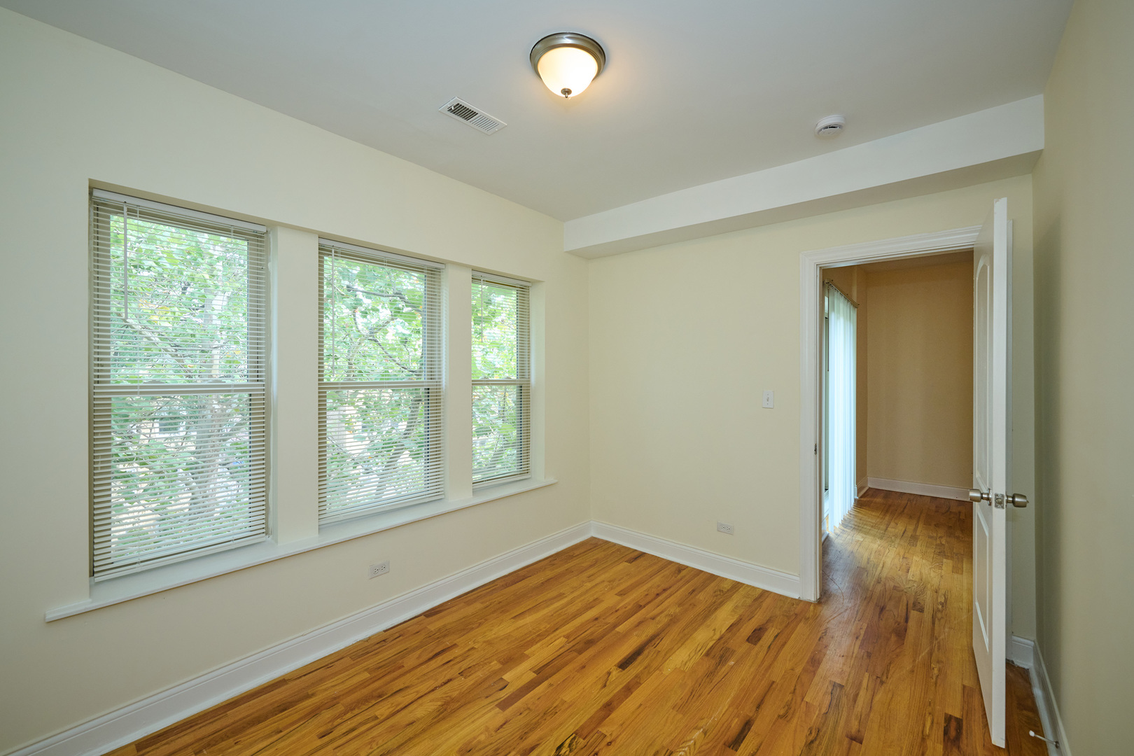 5014 North Harding Avenue, Unit 3S Chicago, IL 60625 - Photo 4 of 13 a view of empty room with wooden floor and fan