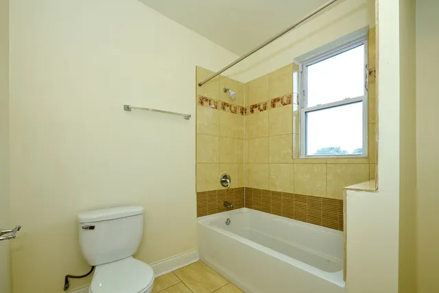 a bathroom with a toilet and a bathtub