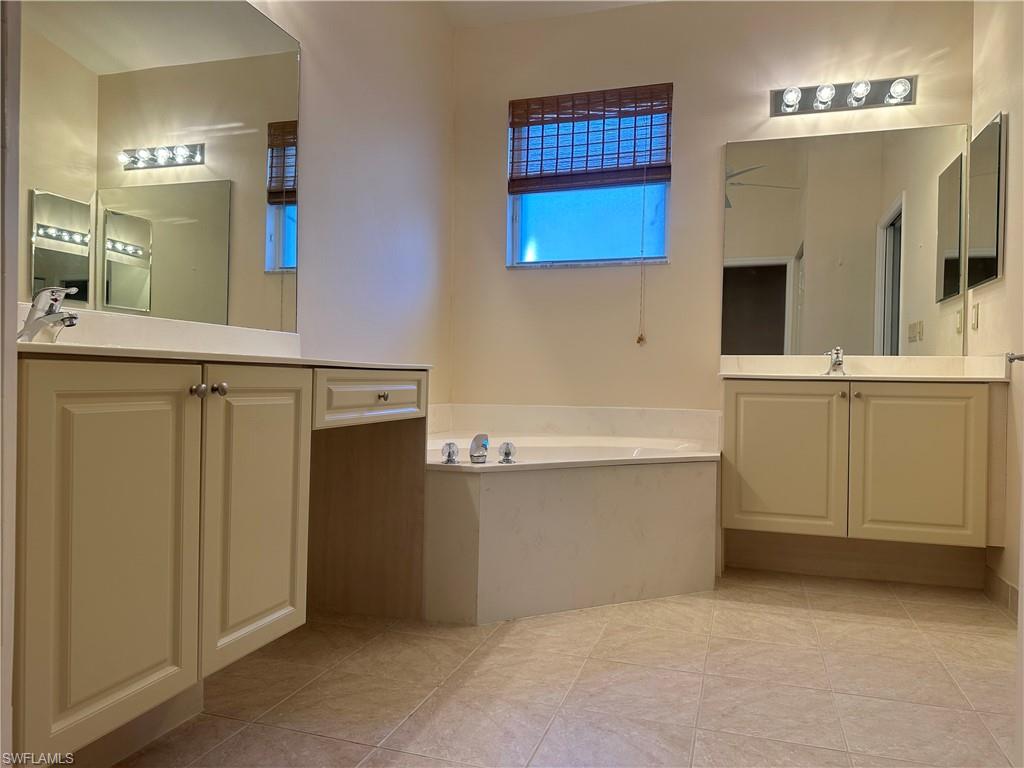 9003 Springview Loop Estero, FL 33928 - Photo 12 of 29 a bathroom with a tub sink and mirror