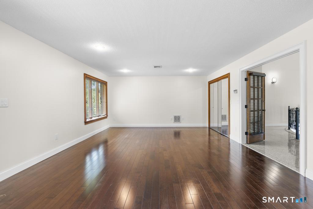 49 Partridge Lane Middletown, CT 06457 - Photo 17 of 39 a view of a big room with wooden floor and windows