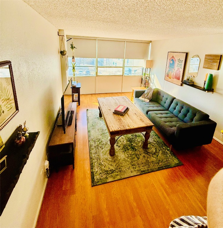 1800 Lavaca Street, Unit A305 Austin, TX 78701 - Photo 3 of 11 a view of a living room and dining room with wooden floor