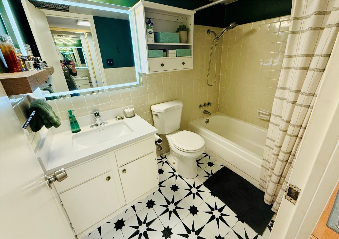 1800 Lavaca Street, Unit A305 Austin, TX 78701 - Photo 7 of 11 a bathroom with a sink toilet and shower