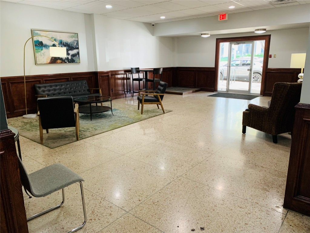 1800 Lavaca Street, Unit A305 Austin, TX 78701 - Photo 9 of 11 a living room with furniture a large window and a flat screen tv