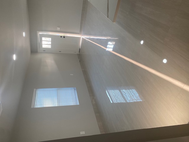 183 Mimosa Road Dale, TX 78616 - Photo 5 of 11 Spacious interior featuring a white entry door with privacy glass, recessed lighting, and light-toned tile flooring