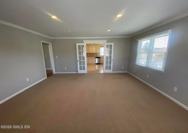 an empty room with windows and closet