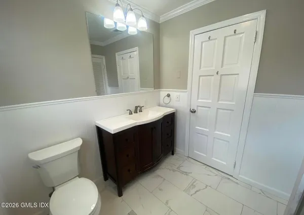 a bathroom with a sink vanity and toilet