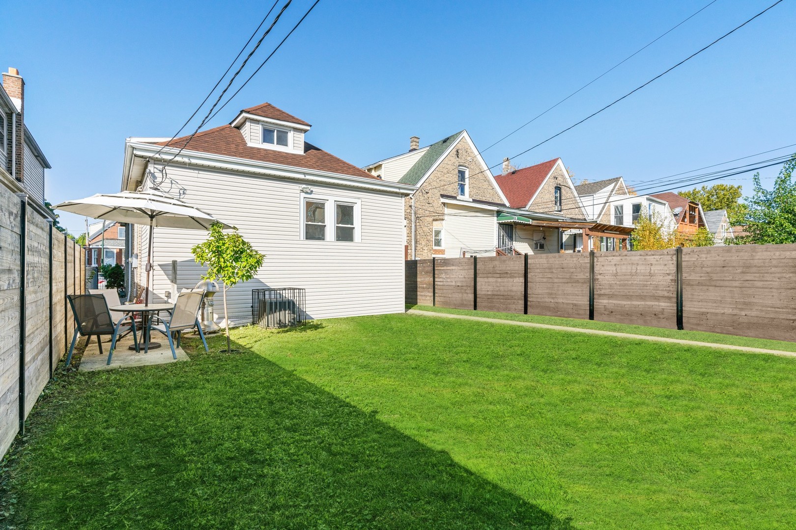 2239 North Keystone Avenue Chicago, IL 60639 - Photo 25 of 31 a view of a house with a yard and sitting area