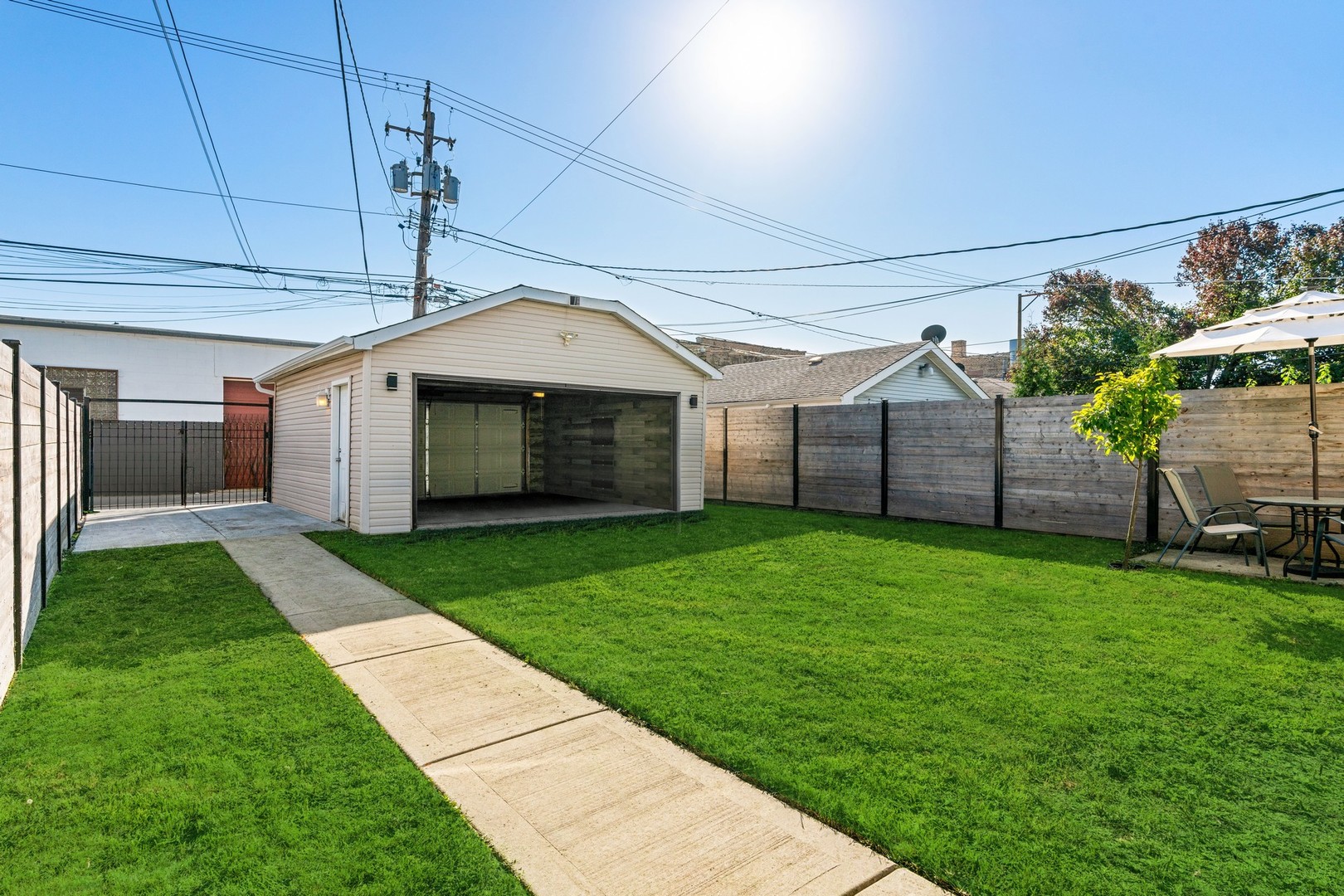 2239 North Keystone Avenue Chicago, IL 60639 - Photo 27 of 31 a front view of a house with a garden and yard