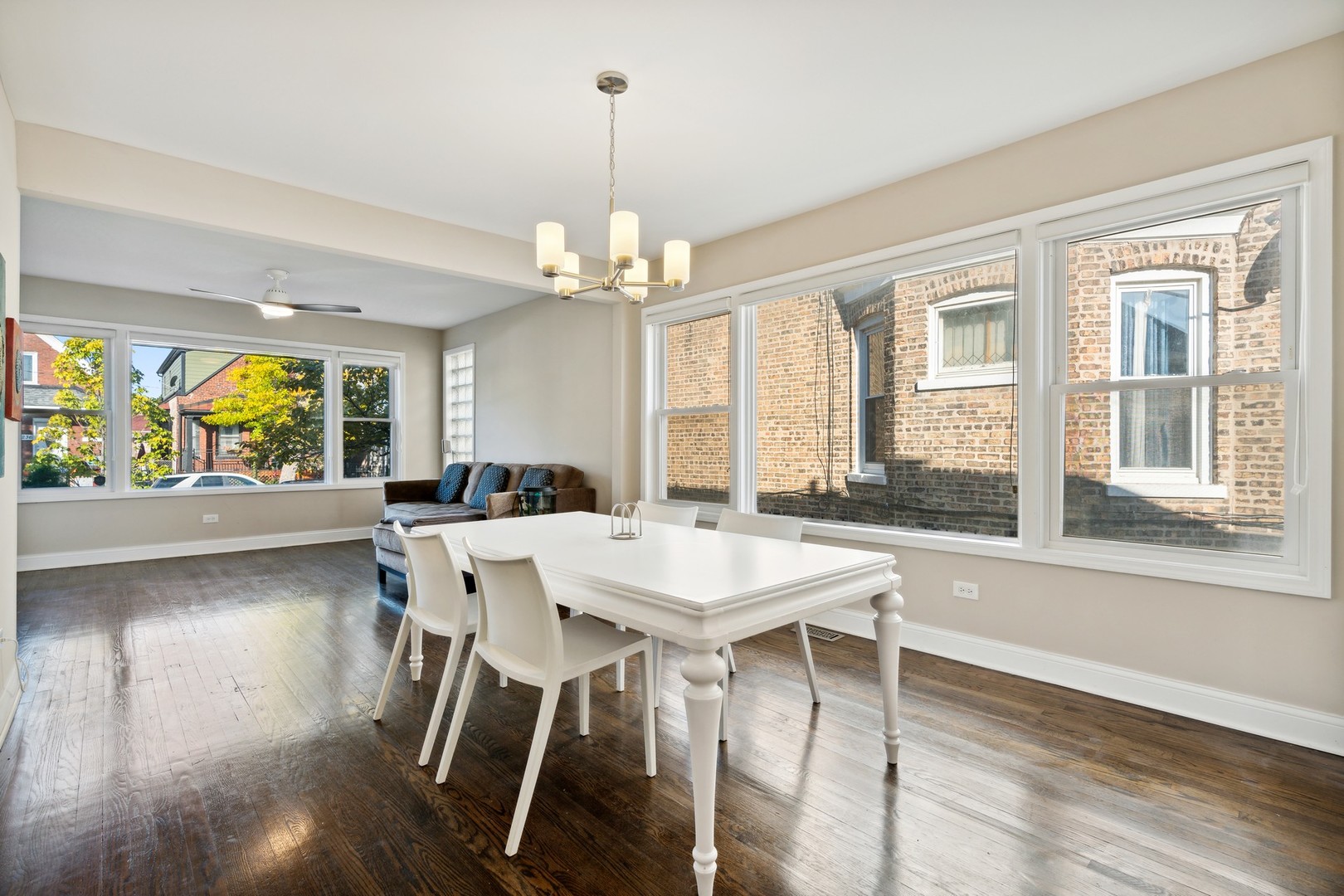 2239 North Keystone Avenue Chicago, IL 60639 - Photo 6 of 31 a view of a dining room with furniture a chandelier and wooden floor