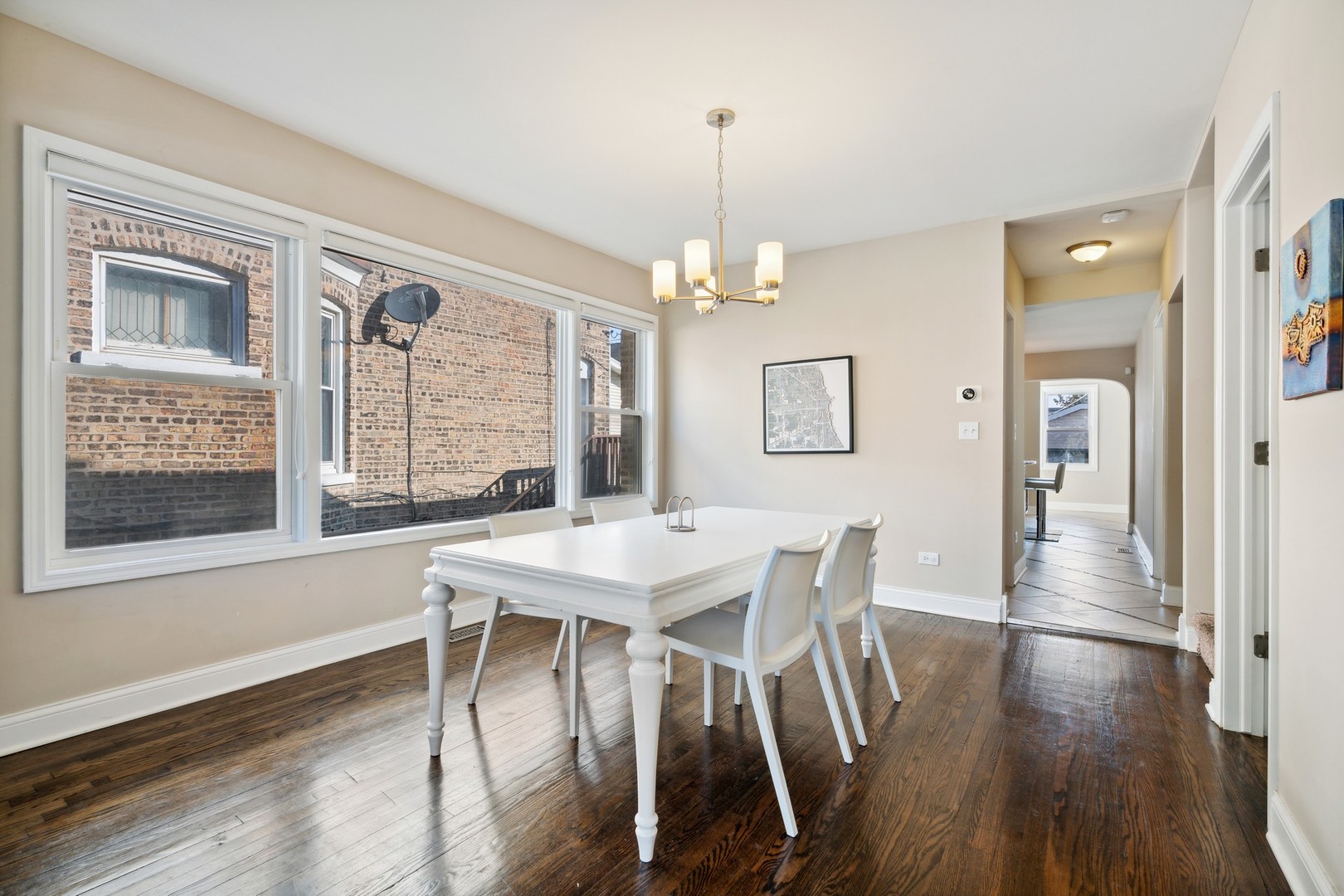 2239 North Keystone Avenue Chicago, IL 60639 - Photo 7 of 31 a view of a dining room with furniture window and wooden floor
