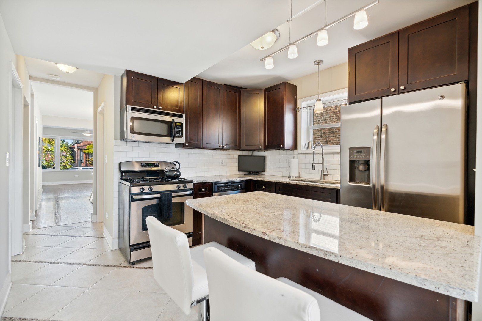 2239 North Keystone Avenue Chicago, IL 60639 - Photo 8 of 31 a kitchen with stainless steel appliances granite countertop a refrigerator a stove top oven a sink and dishwasher