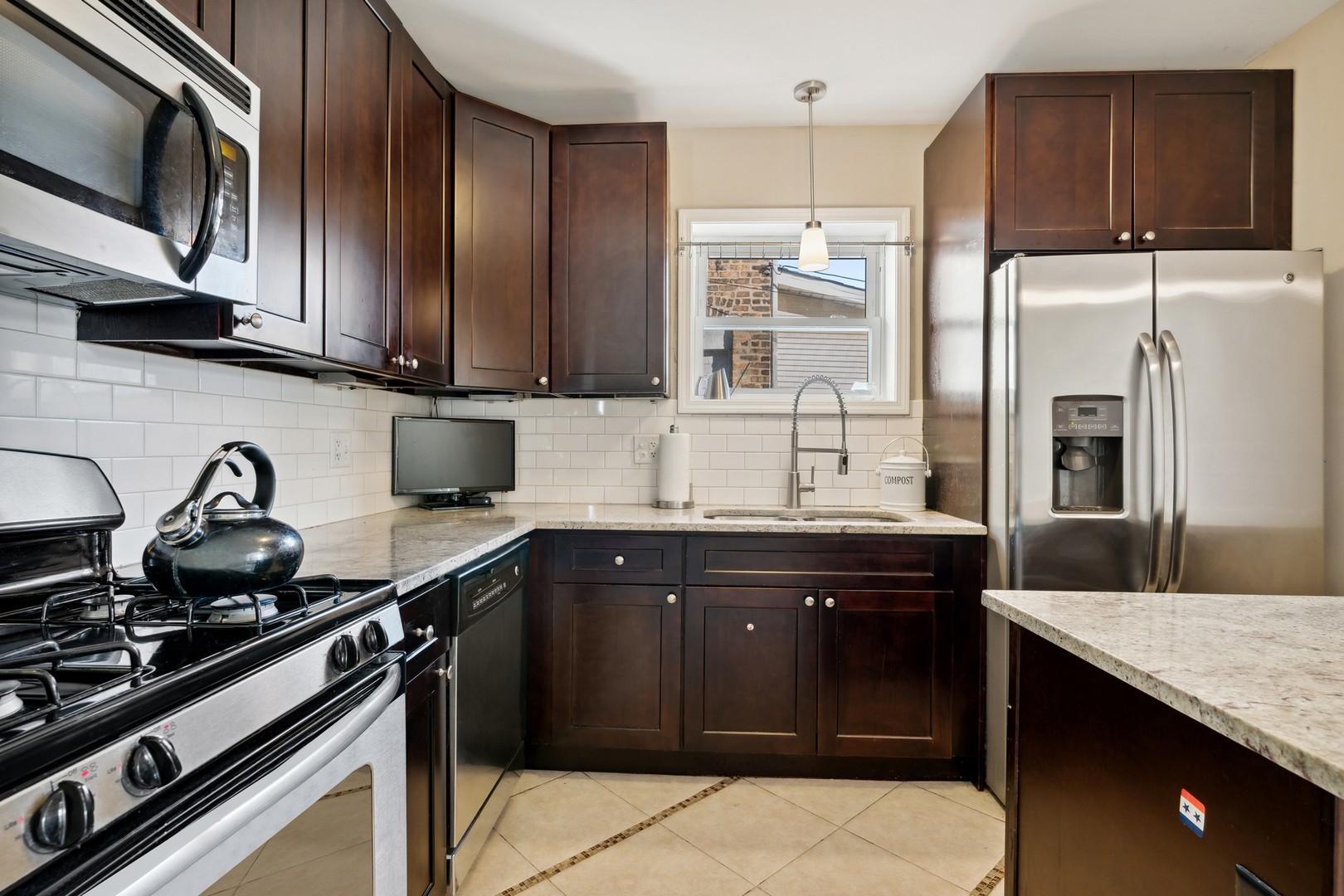 2239 North Keystone Avenue Chicago, IL 60639 - Photo 10 of 31 a kitchen with stainless steel appliances a sink stove and refrigerator