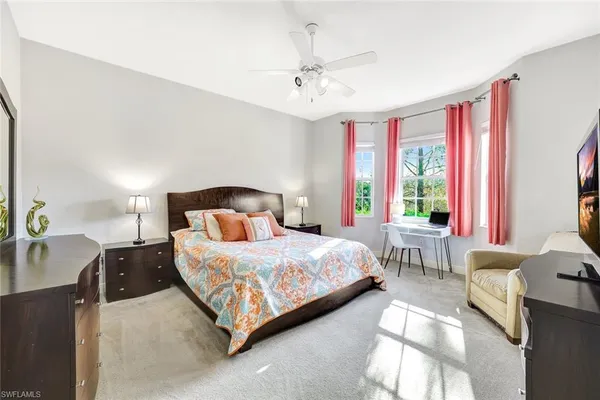 a bedroom with a bed couch and window