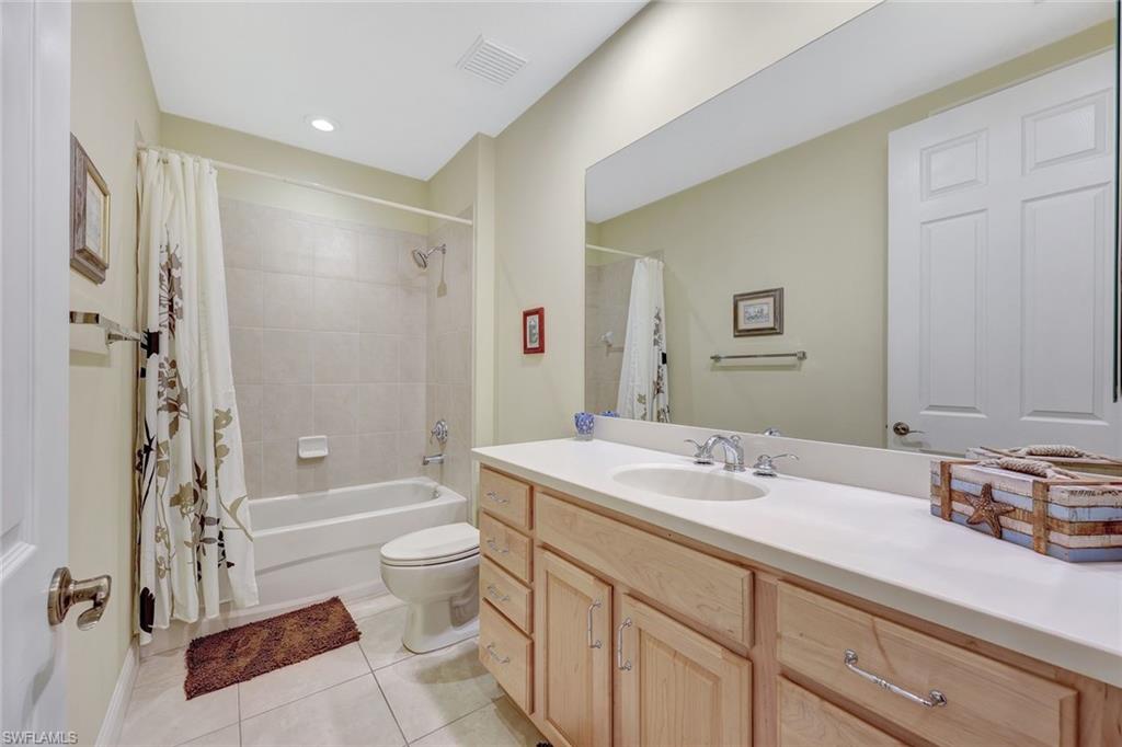 19681 Marino Lake Circle, Unit 1502 Miromar Lakes, FL 33913 - Photo 19 of 26 a bathroom with a sink a toilet and shower