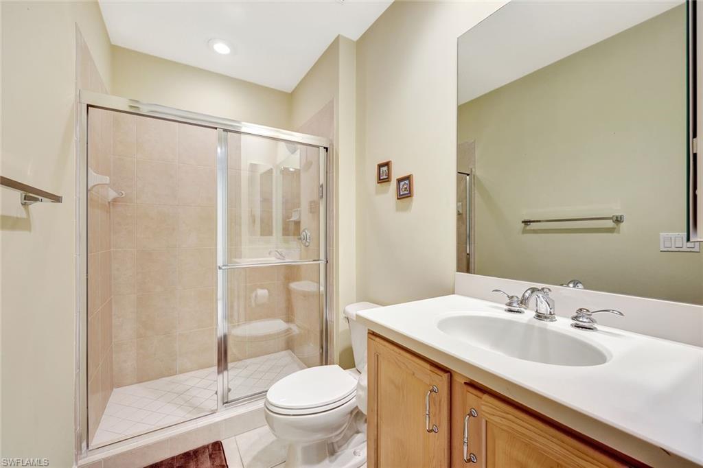 19681 Marino Lake Circle, Unit 1502 Miromar Lakes, FL 33913 - Photo 21 of 26 a bathroom with a sink toilet and shower