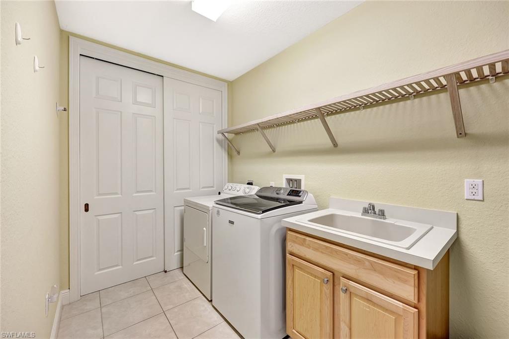 19681 Marino Lake Circle, Unit 1502 Miromar Lakes, FL 33913 - Photo 22 of 26 a utility room with dryer and washer