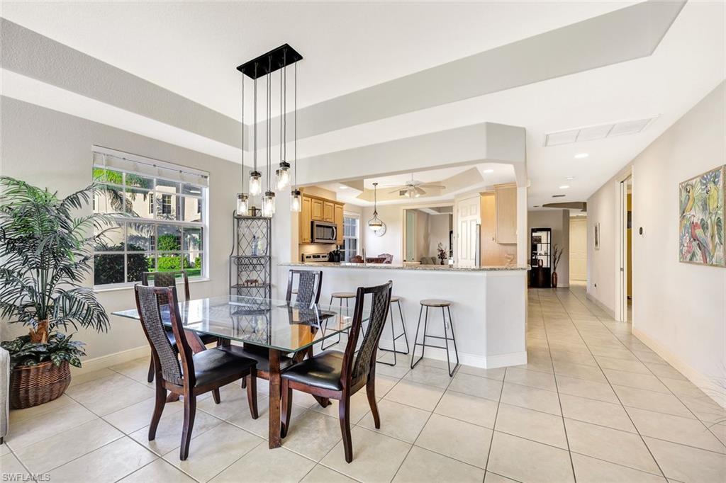 19681 Marino Lake Circle, Unit 1502 Miromar Lakes, FL 33913 - Photo 7 of 26 a dining room with furniture and window