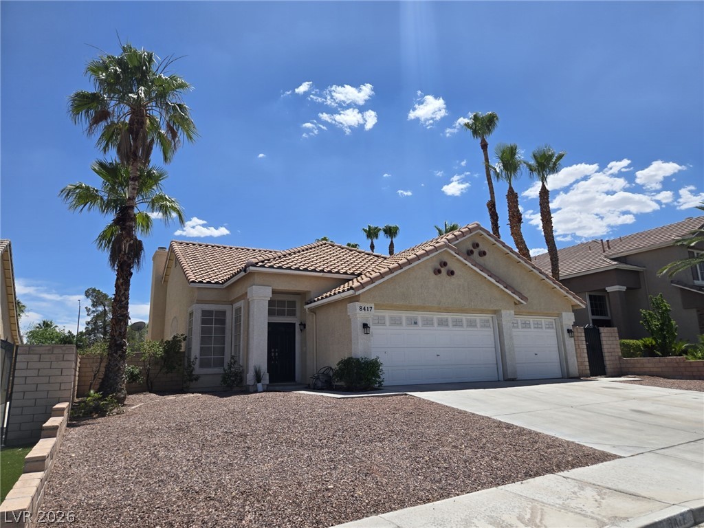8417 San Ramon Drive Las Vegas, NV 89147 - Photo 2 of 33 A well-maintained facade features a tan stucco exterior and a tiled roof.