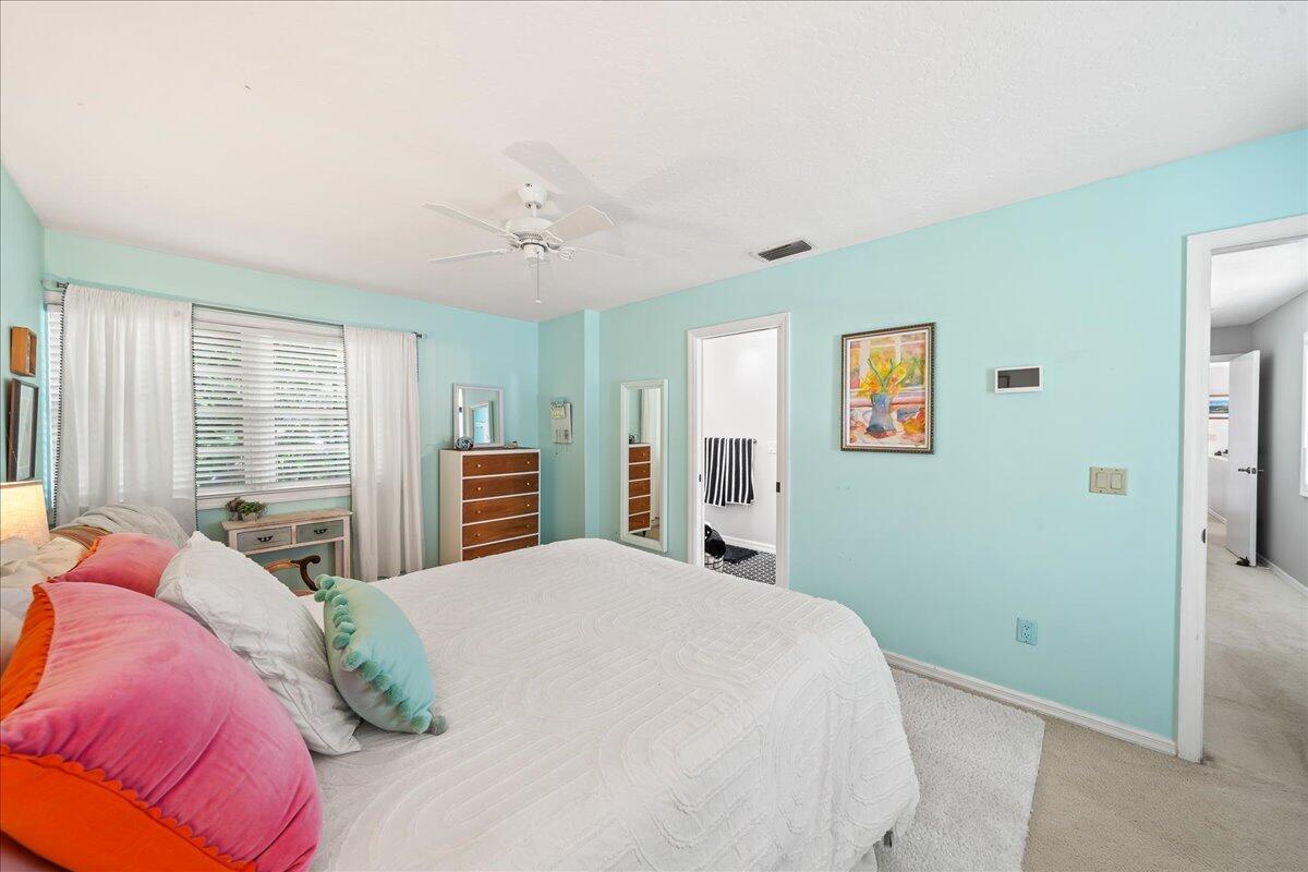 1650 North Riverside Drive Indialantic, FL 32903 - Photo 49 of 88 a bedroom with a large bed and a chandelier