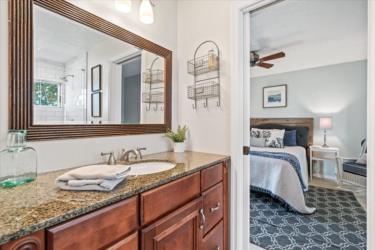 1650 North Riverside Drive Indialantic, FL 32903 - Photo 57 of 88 a bathroom with a granite countertop sink and a mirror