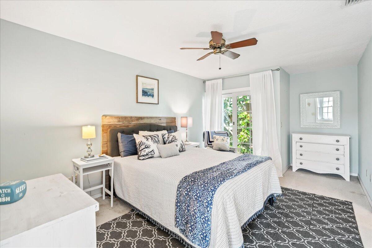 1650 North Riverside Drive Indialantic, FL 32903 - Photo 59 of 88 a bedroom with a bed and a chandelier