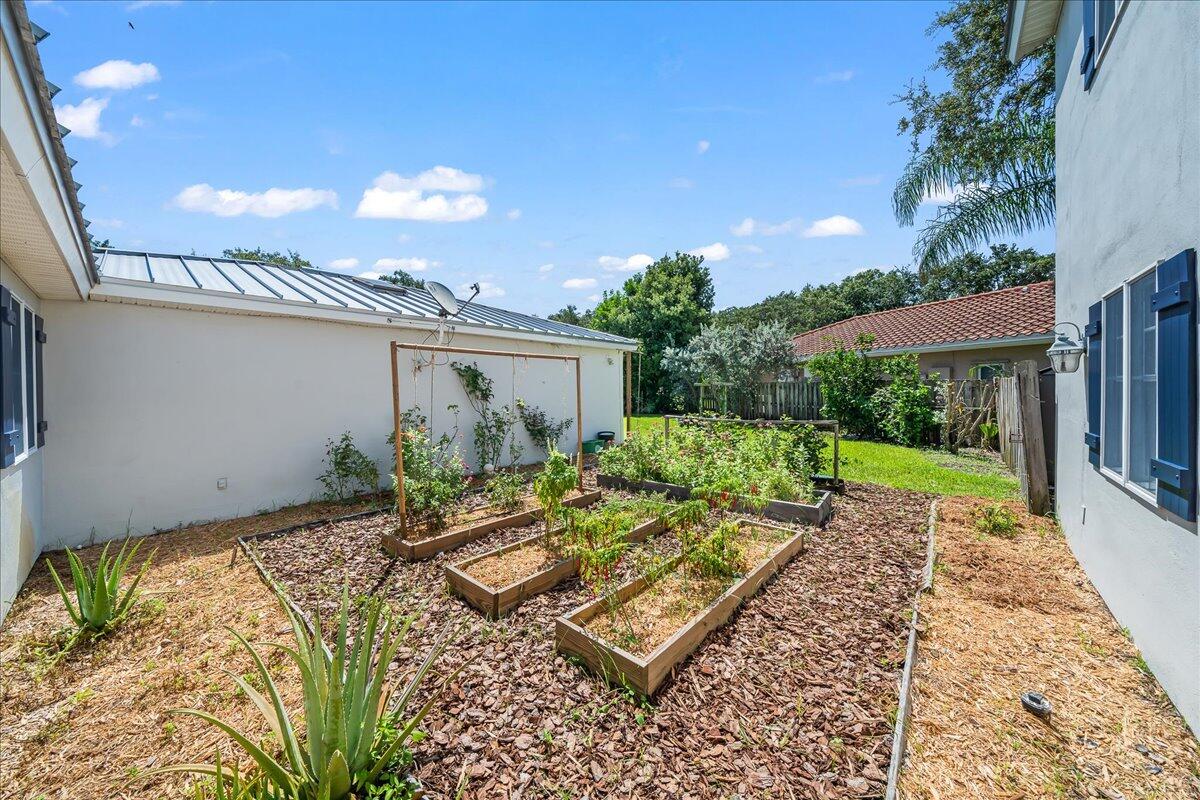 1650 North Riverside Drive Indialantic, FL 32903 - Photo 78 of 88 a view of a backyard with plants and a patio