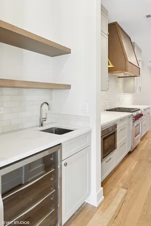 a kitchen with a stove oven and sink