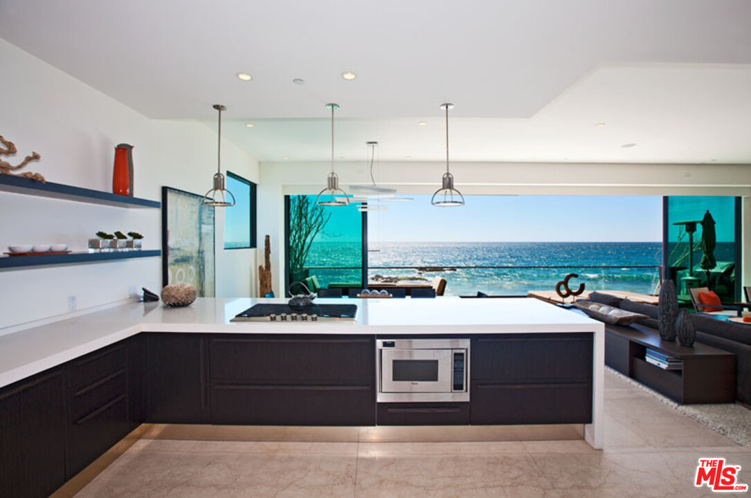 25250 Malibu Road Malibu, CA 90265 - Photo 13 of 31 a kitchen with a stove and a refrigerator