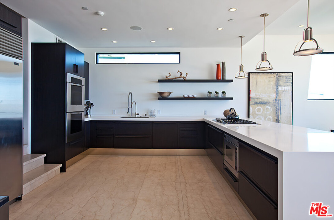 25250 Malibu Road Malibu, CA 90265 - Photo 14 of 31 a kitchen with stainless steel appliances granite countertop a sink a stove and a refrigerator