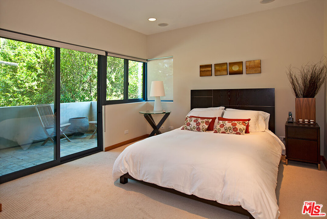 25250 Malibu Road Malibu, CA 90265 - Photo 23 of 31 a bedroom with a large bed and a large window