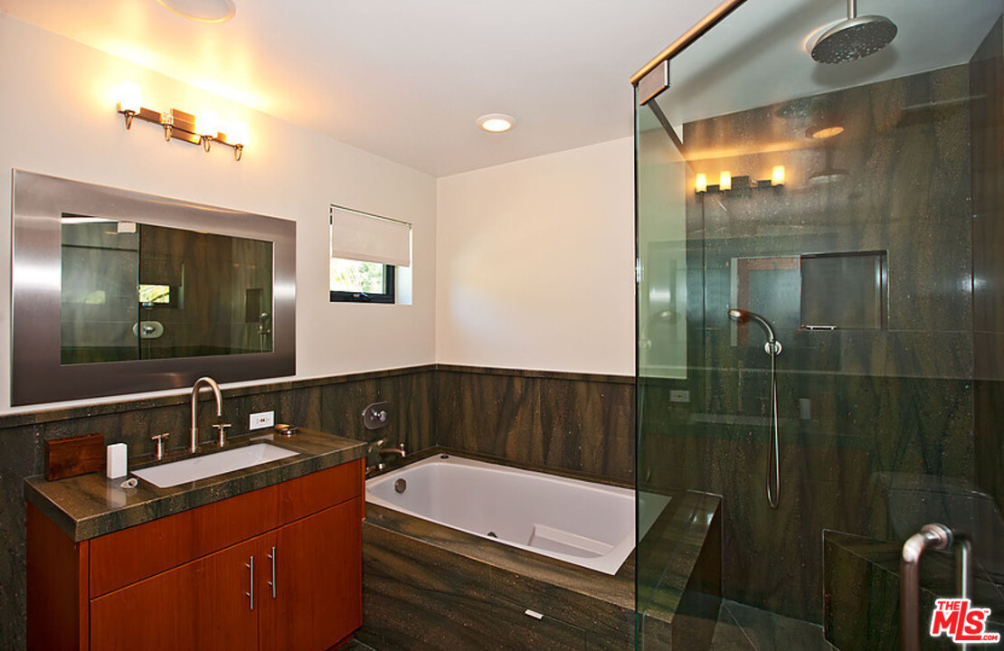 25250 Malibu Road Malibu, CA 90265 - Photo 28 of 31 a bathroom with a sink vanity granite tub shower and a mirror