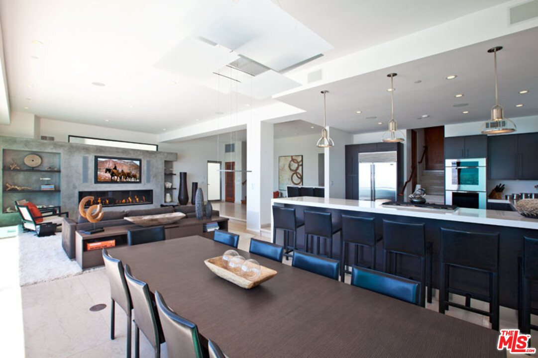 25250 Malibu Road Malibu, CA 90265 - Photo 10 of 31 a living room with lots of furniture and kitchen view