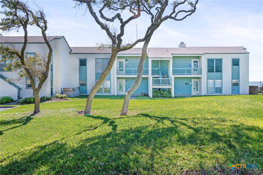 2003 North Fulton Beach Road, Unit 77 Rockport, TX 78382 - Photo 6 of 33 a view of a house with a yard patio and a large tree