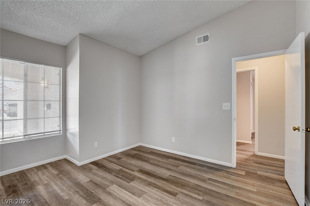 6209 Warm River Road Las Vegas, NV 89108 - Photo 22 of 39 Natural light streams into this generously proportioned room, boasting elegant wood-look flooring.